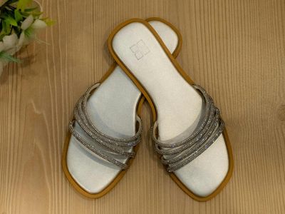 Close-up of a pair of comfortable sports shoes on a wooden floor.